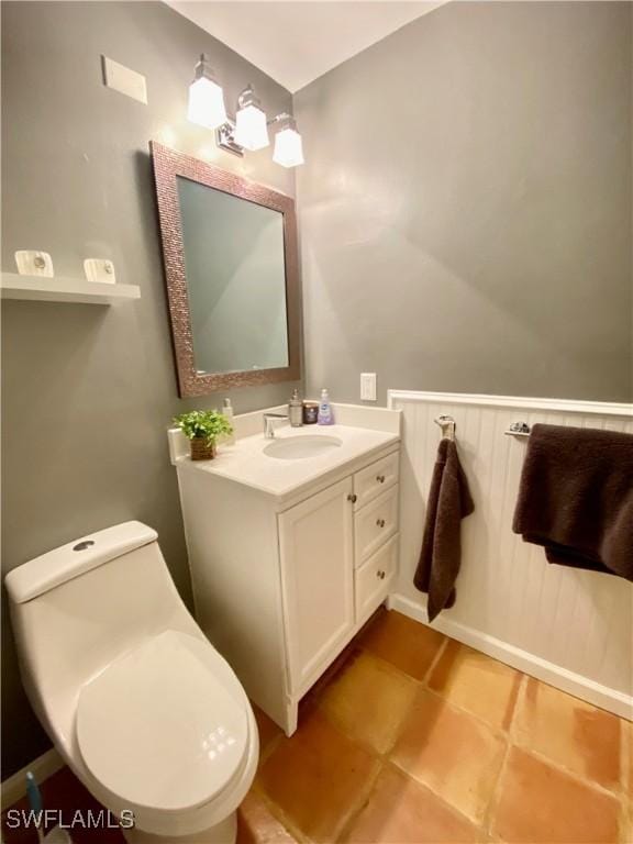 bathroom featuring vanity, tile patterned floors, and toilet