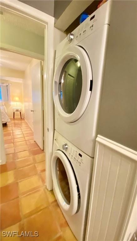 washroom featuring stacked washer and dryer