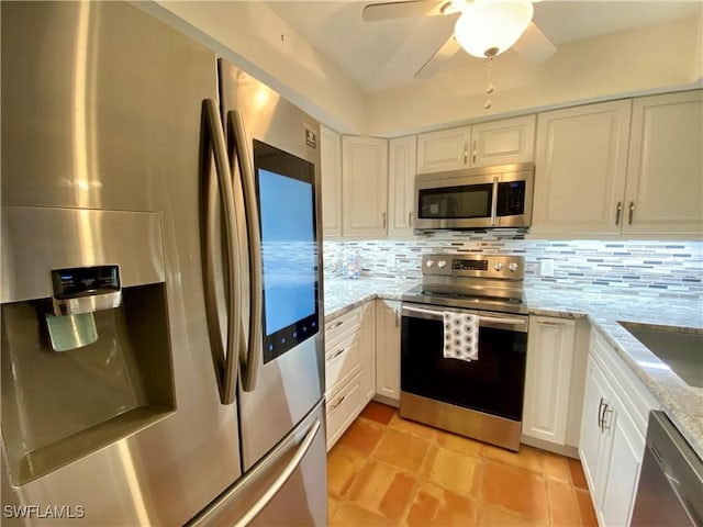 kitchen featuring decorative backsplash, stainless steel appliances, and white cabinets