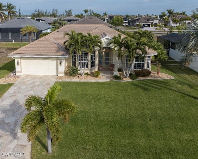 mediterranean / spanish home with a garage and a front lawn