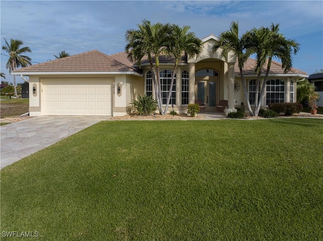 view of front of property with french doors, a garage, and a front lawn