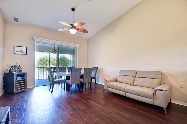 dining space featuring ceiling fan, dark hardwood / wood-style flooring, lofted ceiling, and wine cooler