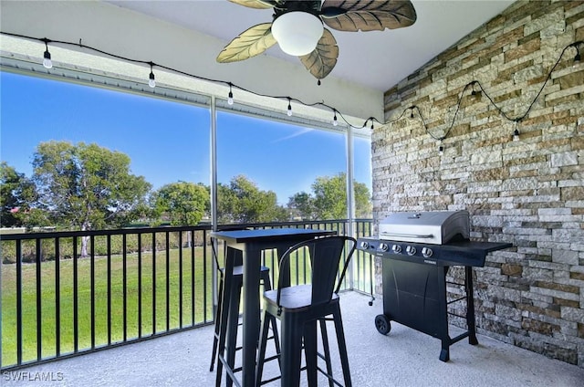 interior space with a balcony, grilling area, and ceiling fan