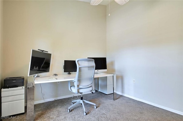 carpeted home office with ceiling fan