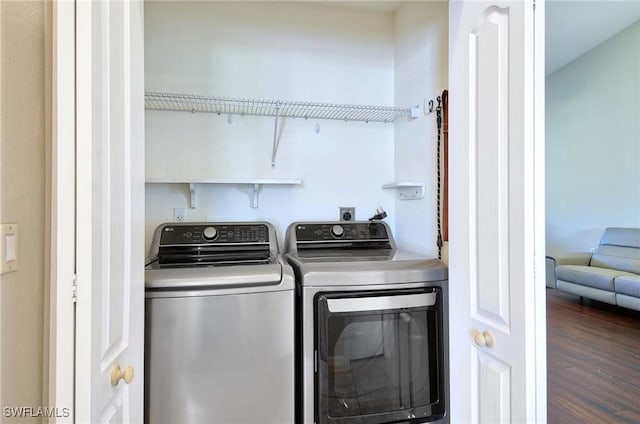 laundry room featuring washer and dryer and dark hardwood / wood-style flooring