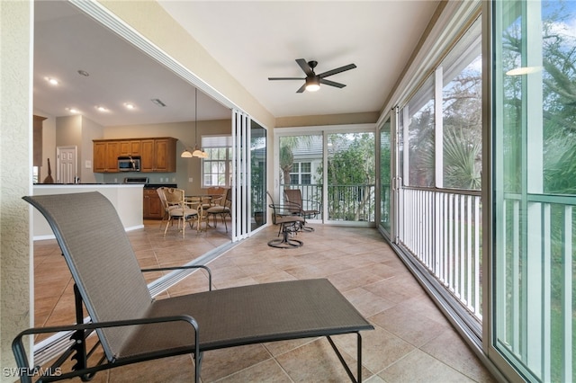 sunroom / solarium featuring a wealth of natural light and ceiling fan