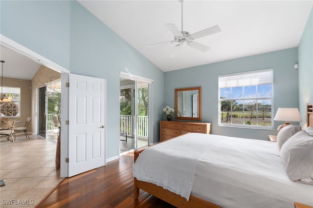 bedroom with access to outside, multiple windows, ceiling fan, and dark wood-type flooring