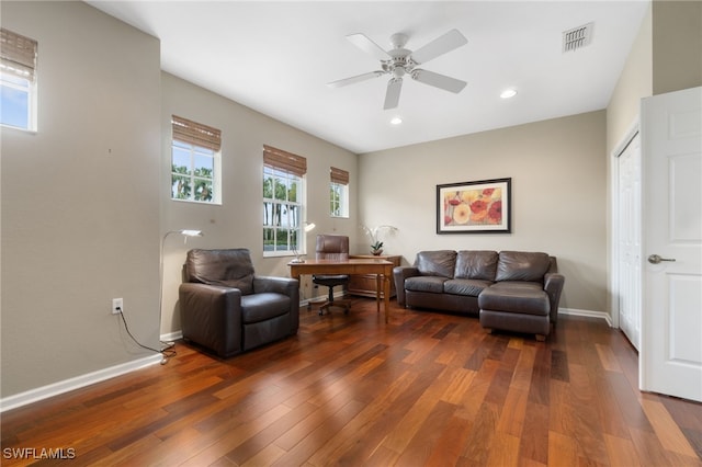 living room with ceiling fan and dark wood-type flooring