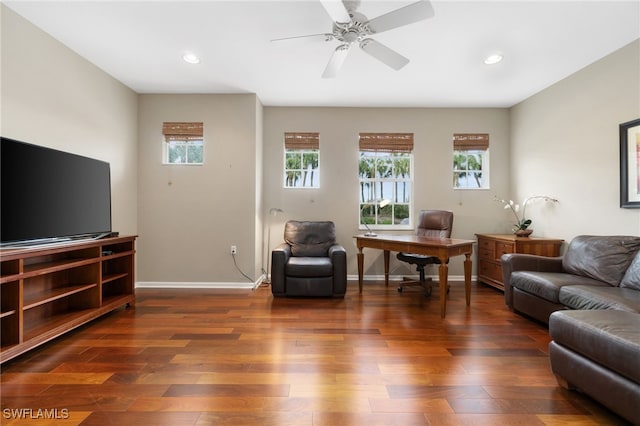 living room featuring ceiling fan and dark wood-type flooring