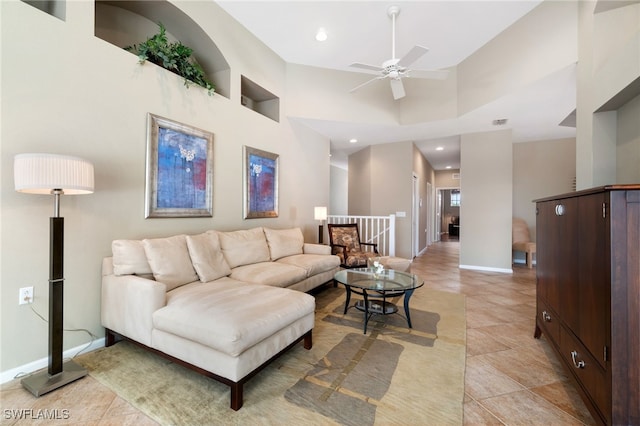 tiled living room featuring a towering ceiling and ceiling fan