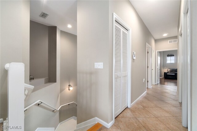 hallway featuring light tile patterned floors