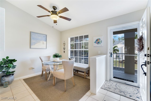 dining room featuring ceiling fan, light tile patterned floors, and vaulted ceiling