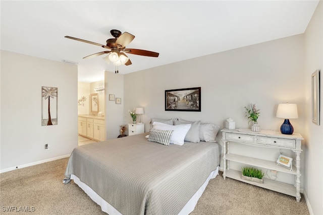 carpeted bedroom with ceiling fan and connected bathroom