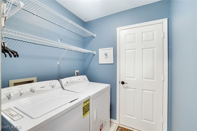 laundry area featuring light tile patterned floors and washer and dryer