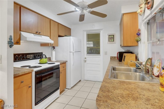 kitchen featuring light tile patterned flooring, under cabinet range hood, white appliances, a sink, and light countertops