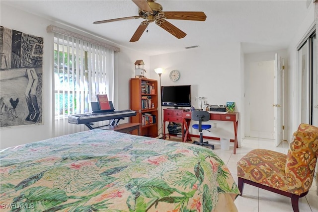 bedroom with ceiling fan, visible vents, and tile patterned floors