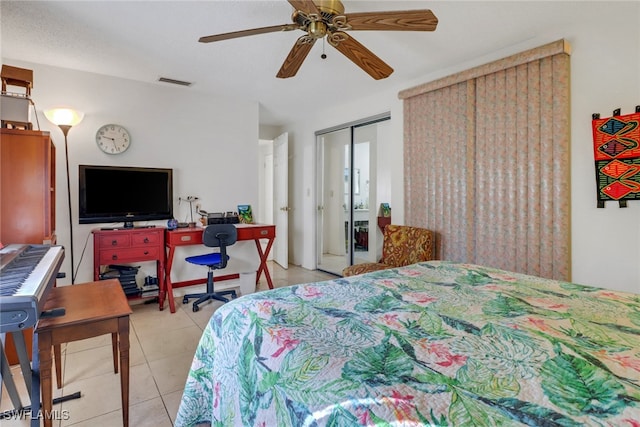 bedroom featuring light tile patterned floors, visible vents, and a ceiling fan