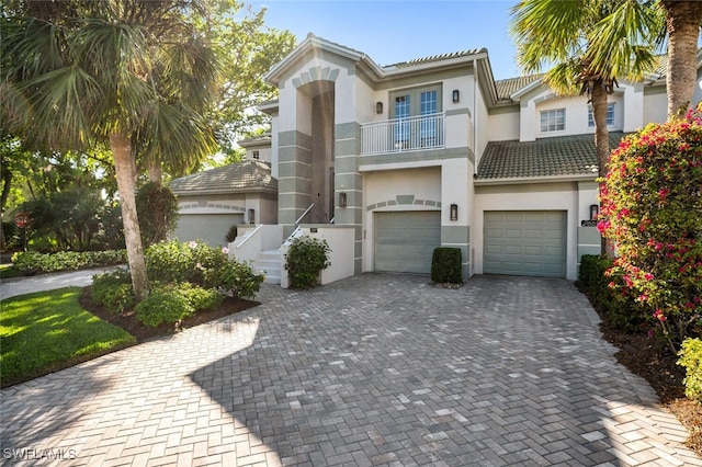 view of front of house featuring a garage and a balcony