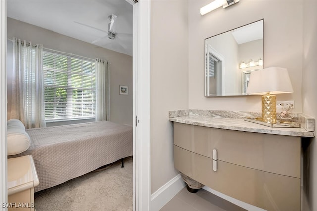 bathroom with ceiling fan, tile patterned flooring, and vanity