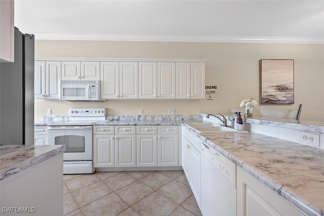 kitchen featuring ornamental molding, white appliances, sink, light tile patterned floors, and white cabinets