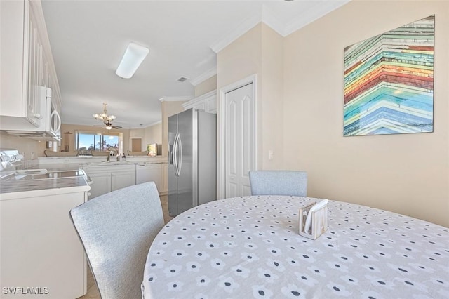 dining room with washer / clothes dryer, crown molding, and sink