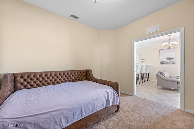 bedroom featuring a notable chandelier and light colored carpet