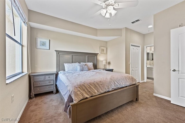 bedroom with carpet flooring, ensuite bath, ceiling fan, and a closet