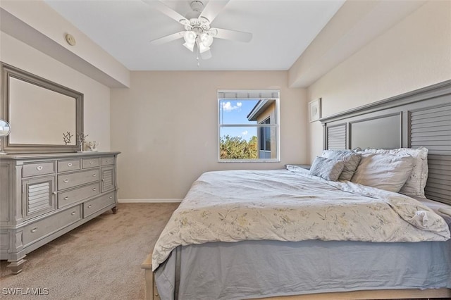 bedroom with ceiling fan and light colored carpet