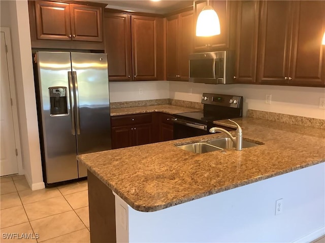 kitchen featuring kitchen peninsula, appliances with stainless steel finishes, light stone countertops, sink, and light tile patterned floors