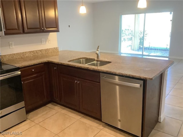 kitchen with hanging light fixtures, sink, light tile patterned floors, kitchen peninsula, and stainless steel appliances