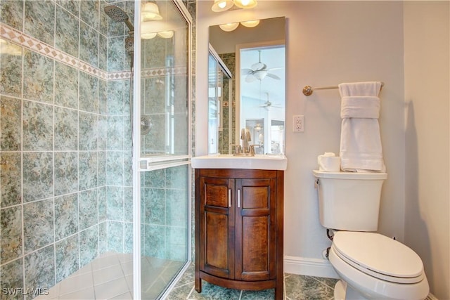 bathroom featuring ceiling fan, tile patterned floors, toilet, vanity, and a shower with shower door