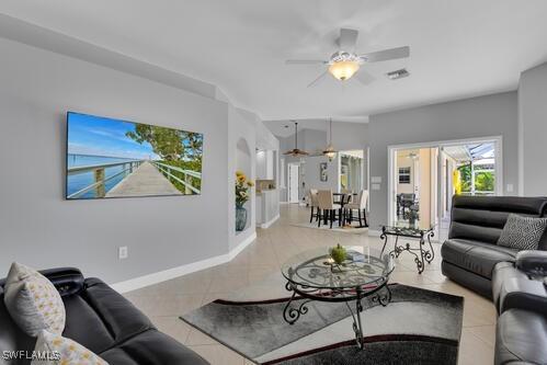 tiled living room featuring ceiling fan