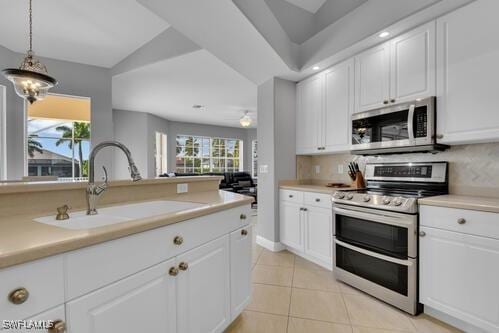 kitchen featuring white cabinetry, sink, and appliances with stainless steel finishes