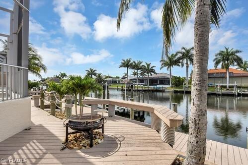 view of dock featuring a water view and a fire pit