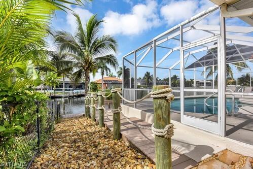 dock area with a water view and glass enclosure