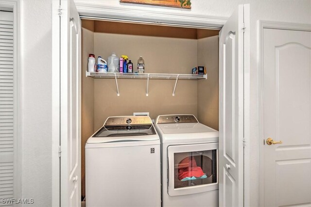 laundry area with laundry area and separate washer and dryer