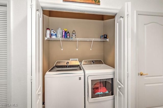 washroom featuring laundry area and washer and clothes dryer