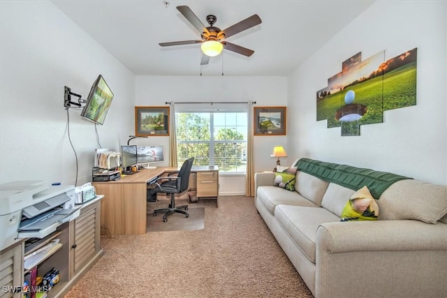 carpeted home office featuring ceiling fan