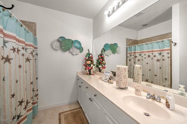 full bath with a shower with curtain, vanity, baseboards, and tile patterned floors