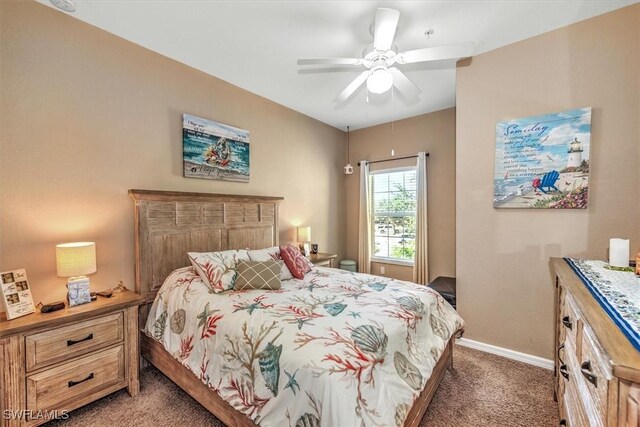 bedroom with dark colored carpet, a ceiling fan, and baseboards