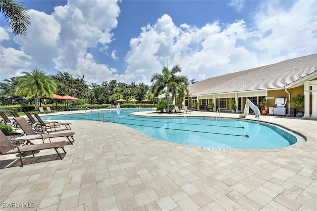 community pool featuring a patio area