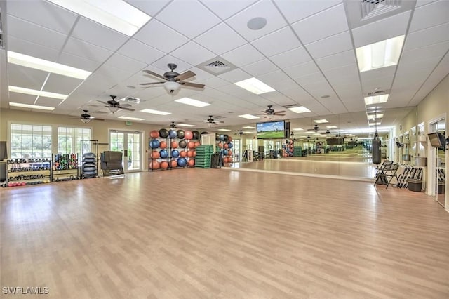 workout area featuring a drop ceiling, wood finished floors, and visible vents