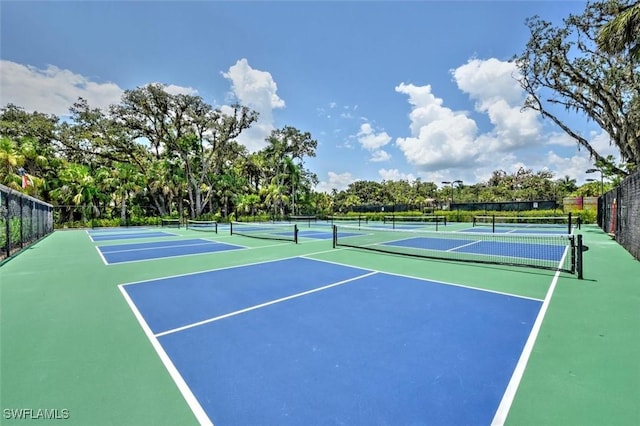 view of tennis court featuring fence