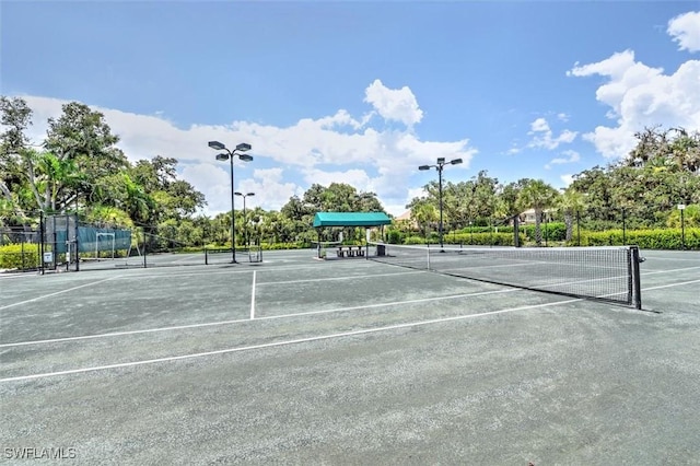 view of tennis court with fence