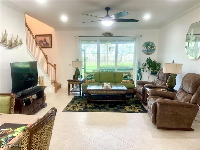 living area with stairs, light tile patterned floors, a ceiling fan, and ornamental molding