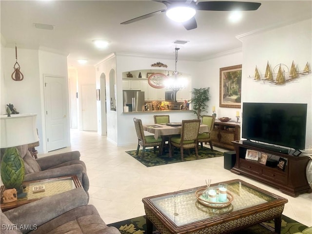 living room featuring visible vents, ornamental molding, arched walkways, light tile patterned floors, and ceiling fan