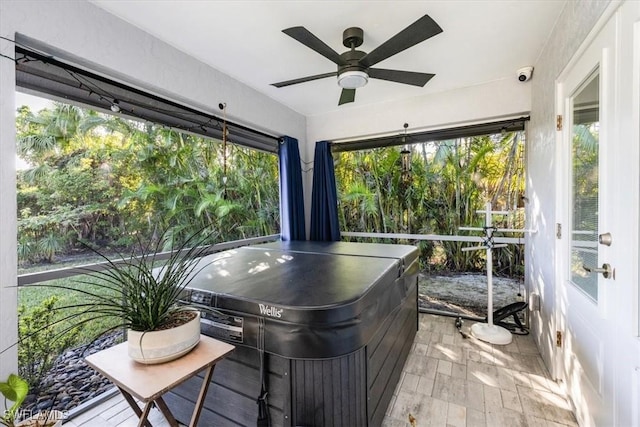 sunroom / solarium featuring a wealth of natural light, a jacuzzi, and ceiling fan