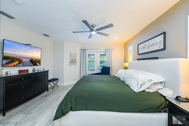 bedroom with access to exterior, french doors, light wood-type flooring, and ceiling fan