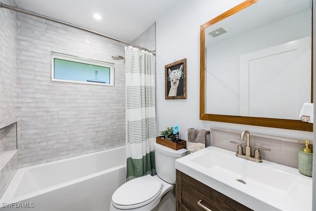 full bathroom featuring vanity, shower / bath combination with curtain, and toilet