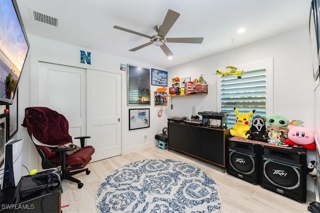 recreation room featuring ceiling fan and light wood-type flooring